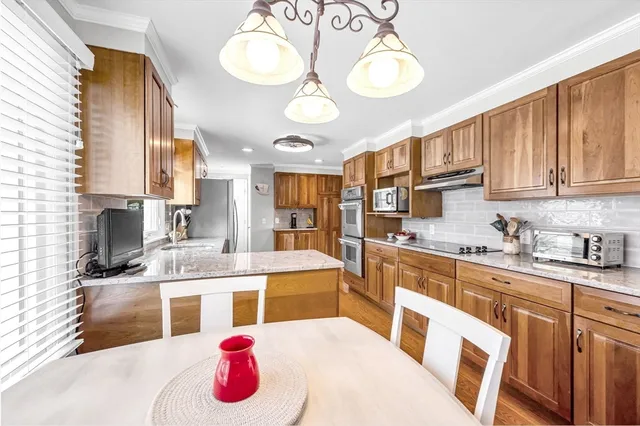 a kitchen with a sink stove and cabinets
