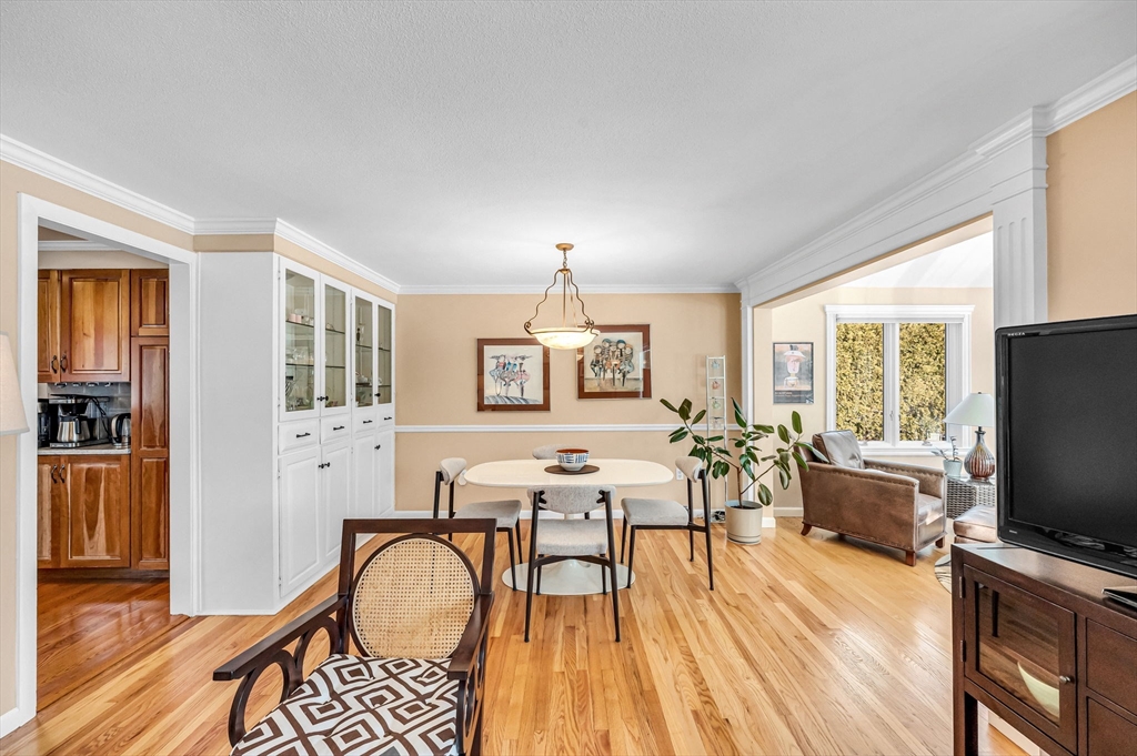 361 Frank Smith Road Longmeadow, MA 01106 - Photo 9 of 42 a living room with furniture a dining table and a flat screen tv with wooden floor