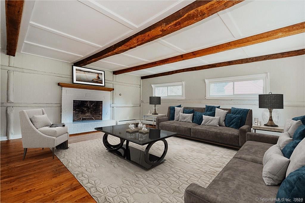 a living room with furniture a rug and a fireplace