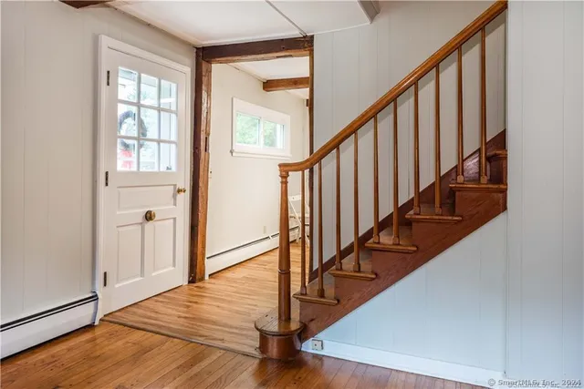 a view of an entryway with wooden floor and stairs