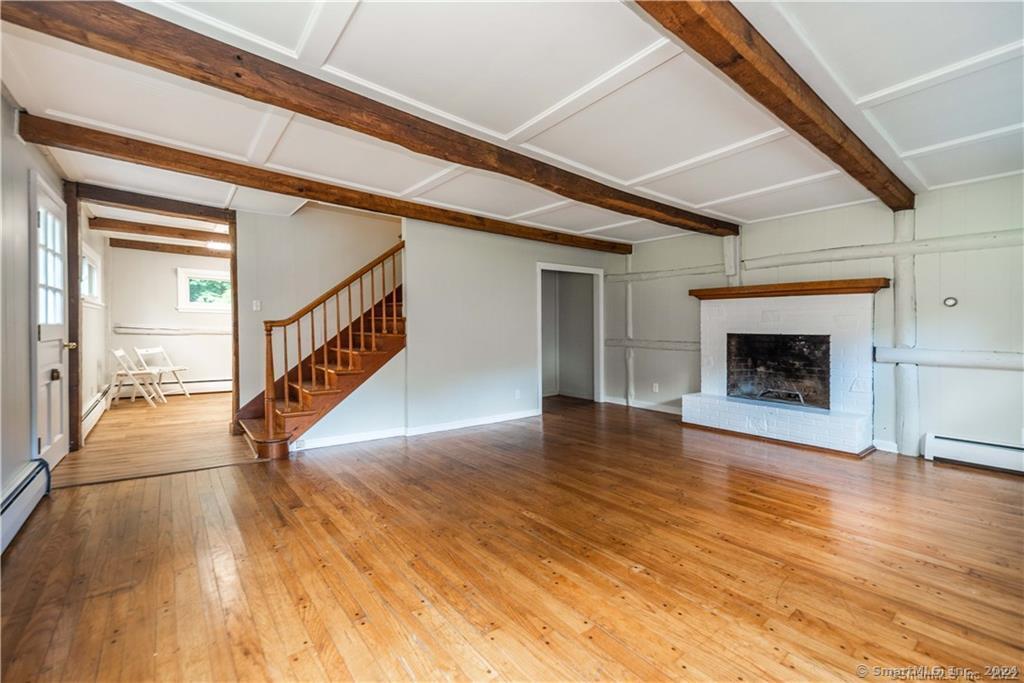 279 Fenn Road Cheshire, CT 06410 - Photo 13 of 28 a view of a livingroom with wooden floor and a fireplace