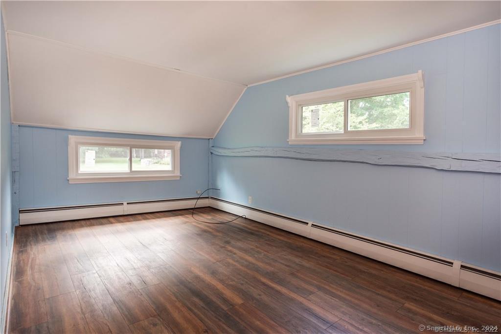 279 Fenn Road Cheshire, CT 06410 - Photo 15 of 28 a view of an empty room with wooden floor and a window