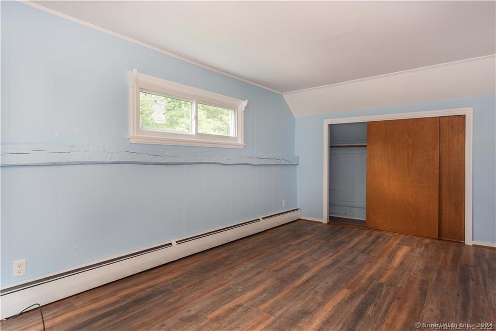 279 Fenn Road Cheshire, CT 06410 - Photo 16 of 28 an empty room with wooden floor and windows