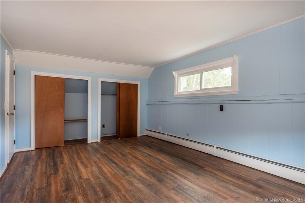 279 Fenn Road Cheshire, CT 06410 - Photo 18 of 28 an empty room with wooden floor closet and windows