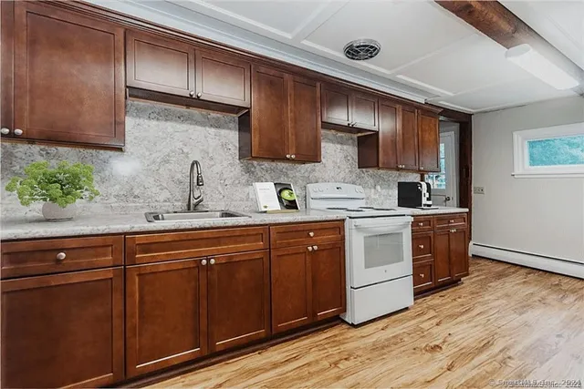 a kitchen with sink cabinets and wooden floor