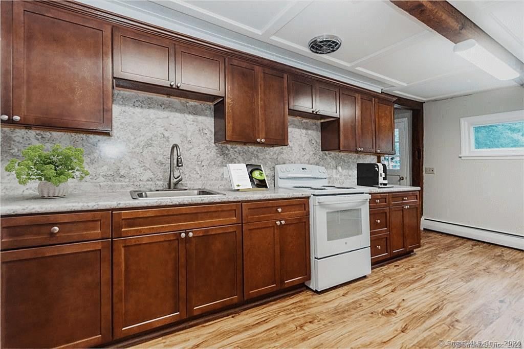 279 Fenn Road Cheshire, CT 06410 - Photo 3 of 28 a kitchen with sink cabinets and wooden floor