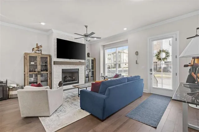 a living room with furniture a flat screen tv and a fireplace