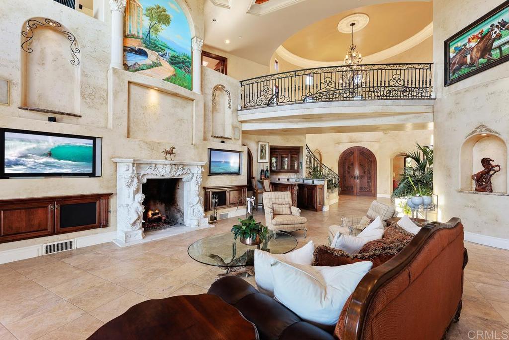 4633 Olive Hill Road Fallbrook, CA 92028 - Photo 5 of 10 a living room with furniture a fireplace and a flat screen tv