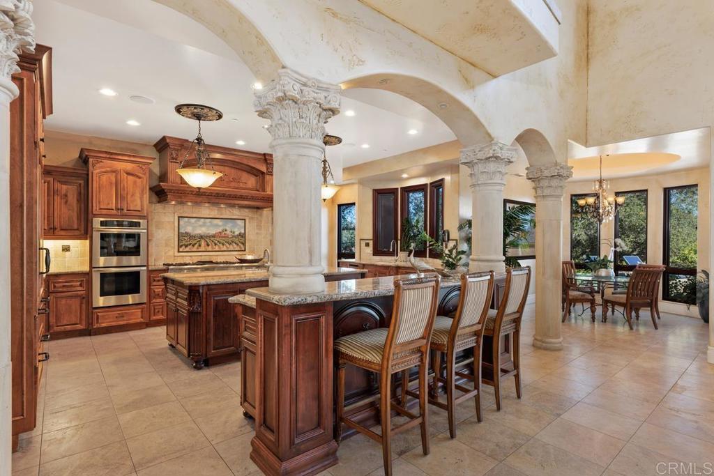 4633 Olive Hill Road Fallbrook, CA 92028 - Photo 7 of 10 a view of a dining room with furniture and chandelier