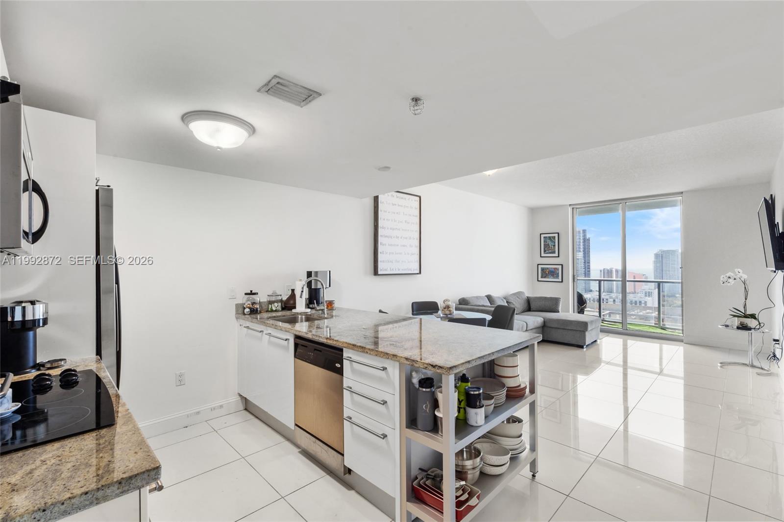 185 Southwest 7th Street, Unit 3414 Miami, FL 33130 - Photo 11 of 32 a kitchen with stainless steel appliances granite countertop a sink and cabinets