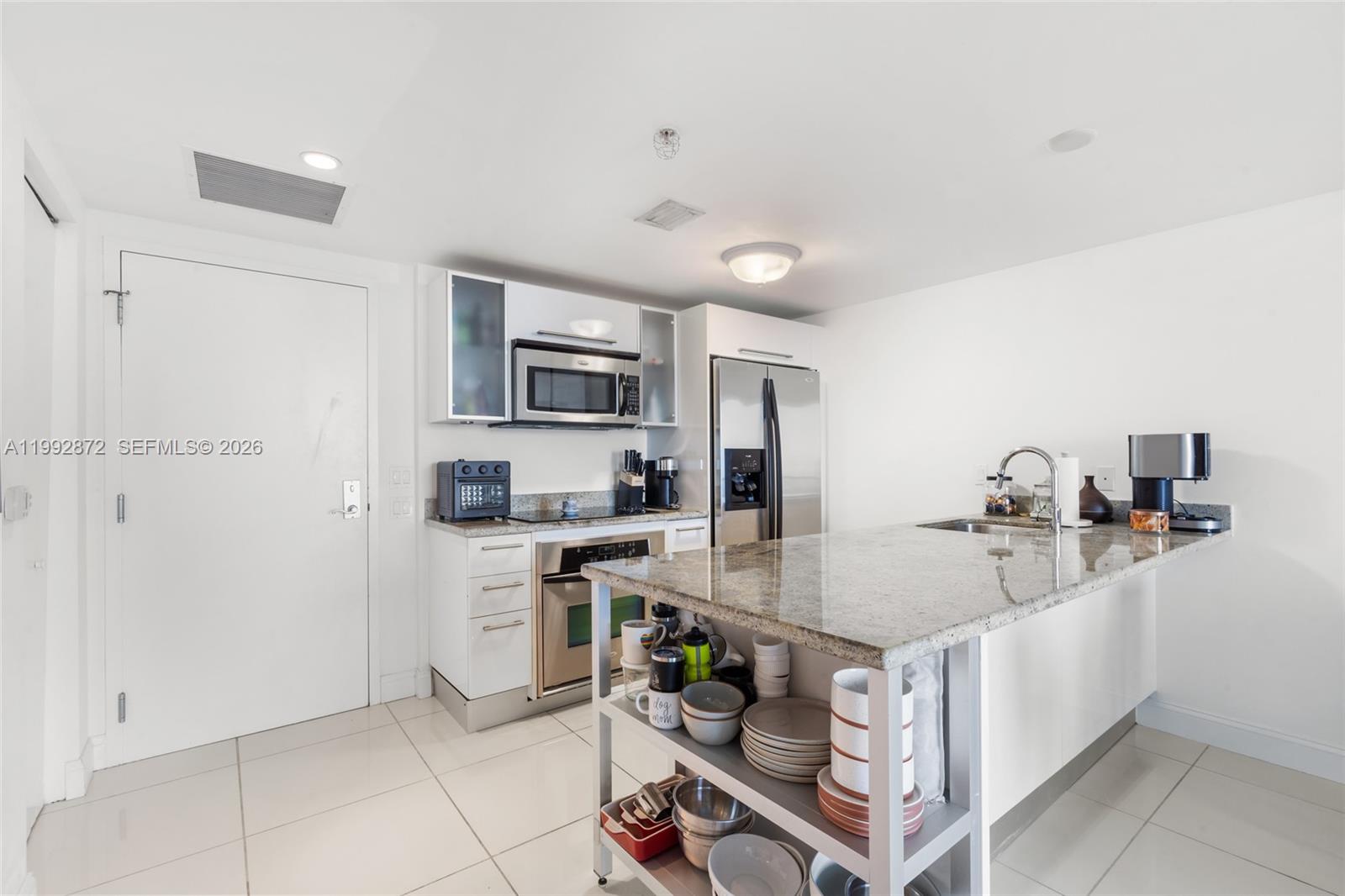 185 Southwest 7th Street, Unit 3414 Miami, FL 33130 - Photo 13 of 32 a kitchen with a sink appliances and cabinets