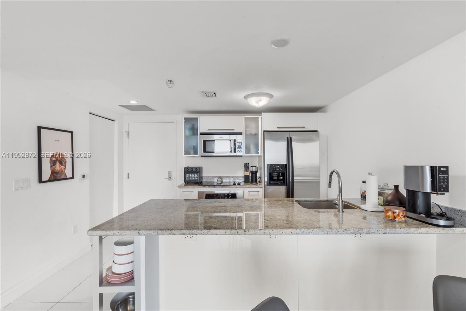 185 Southwest 7th Street, Unit 3414 Miami, FL 33130 - Photo 14 of 32 a kitchen with stainless steel appliances granite countertop a sink and cabinets