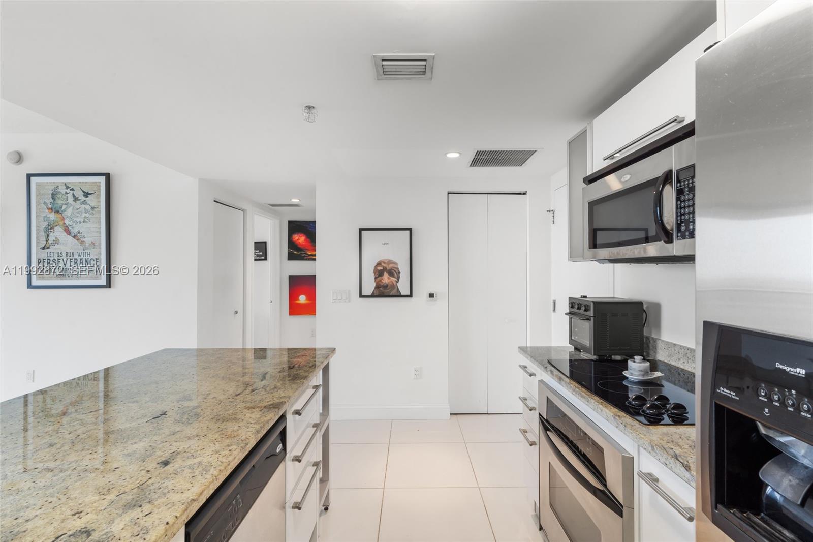 185 Southwest 7th Street, Unit 3414 Miami, FL 33130 - Photo 15 of 32 a kitchen with granite countertop a stove and a sink