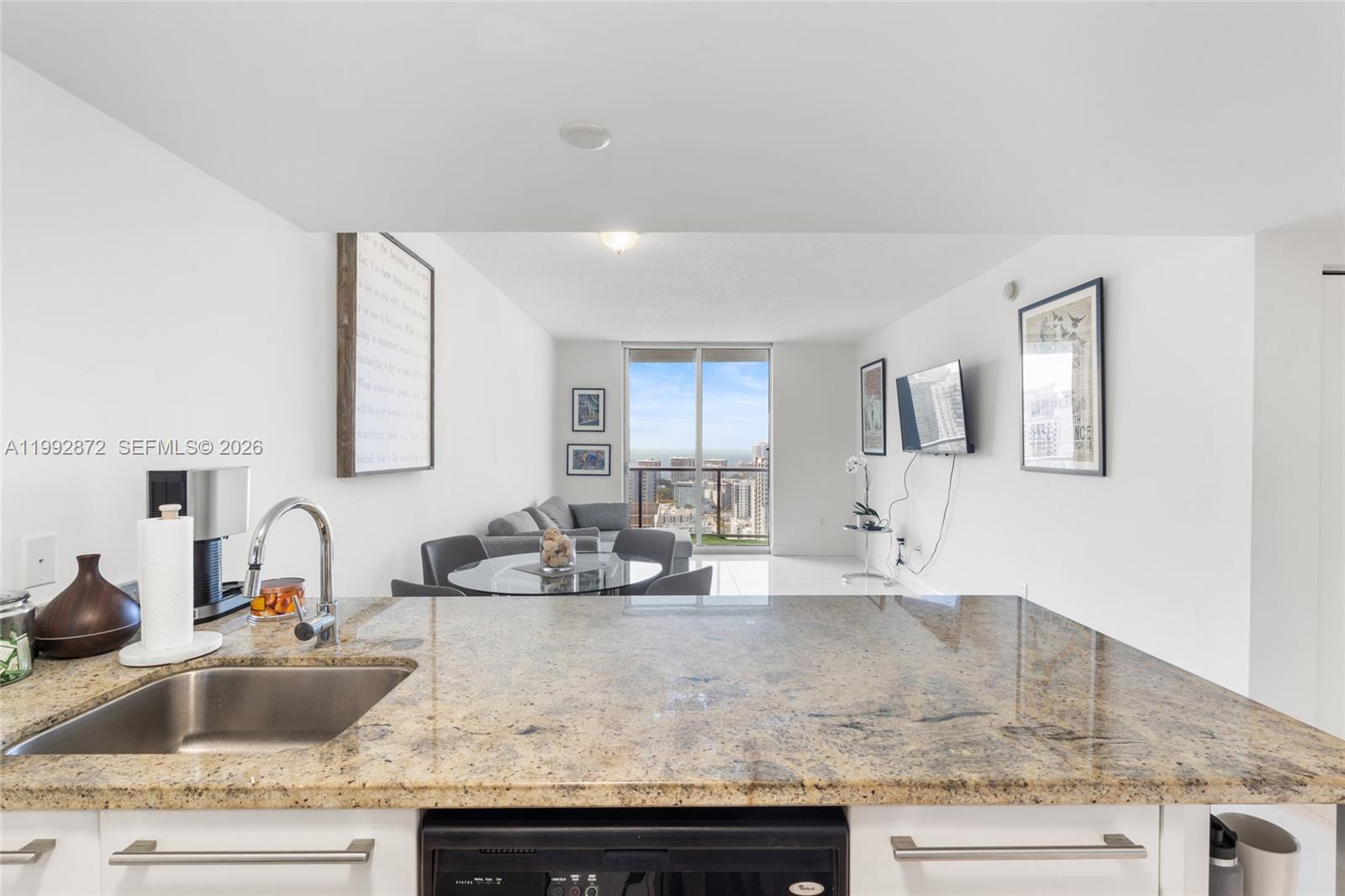 185 Southwest 7th Street, Unit 3414 Miami, FL 33130 - Photo 16 of 32 a kitchen with granite countertop a sink and a granite counter tops