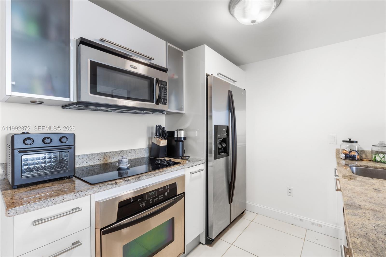 185 Southwest 7th Street, Unit 3414 Miami, FL 33130 - Photo 17 of 32 a kitchen with granite countertop cabinets stainless steel appliances and a counter space