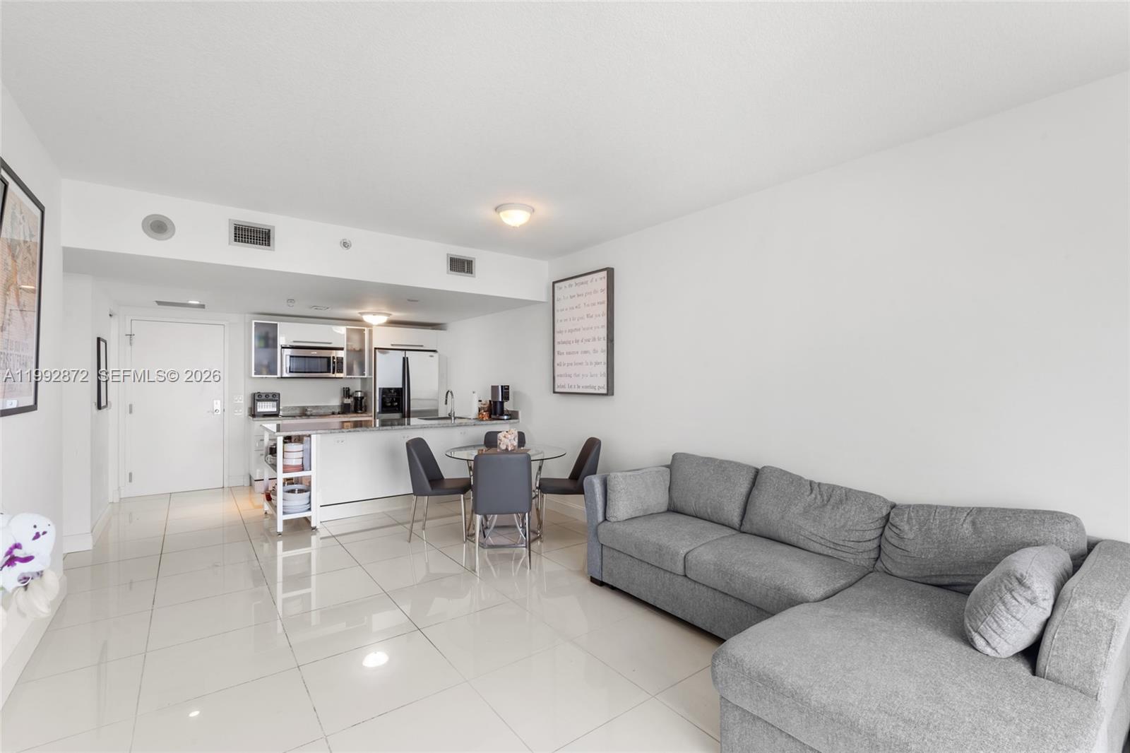 185 Southwest 7th Street, Unit 3414 Miami, FL 33130 - Photo 22 of 32 a living room with furniture and view of kitchen