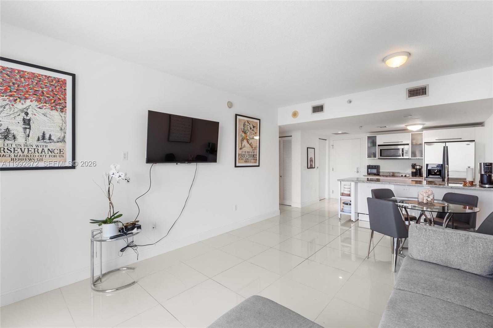 185 Southwest 7th Street, Unit 3414 Miami, FL 33130 - Photo 23 of 32 a view of a livingroom with furniture and flat screen tv