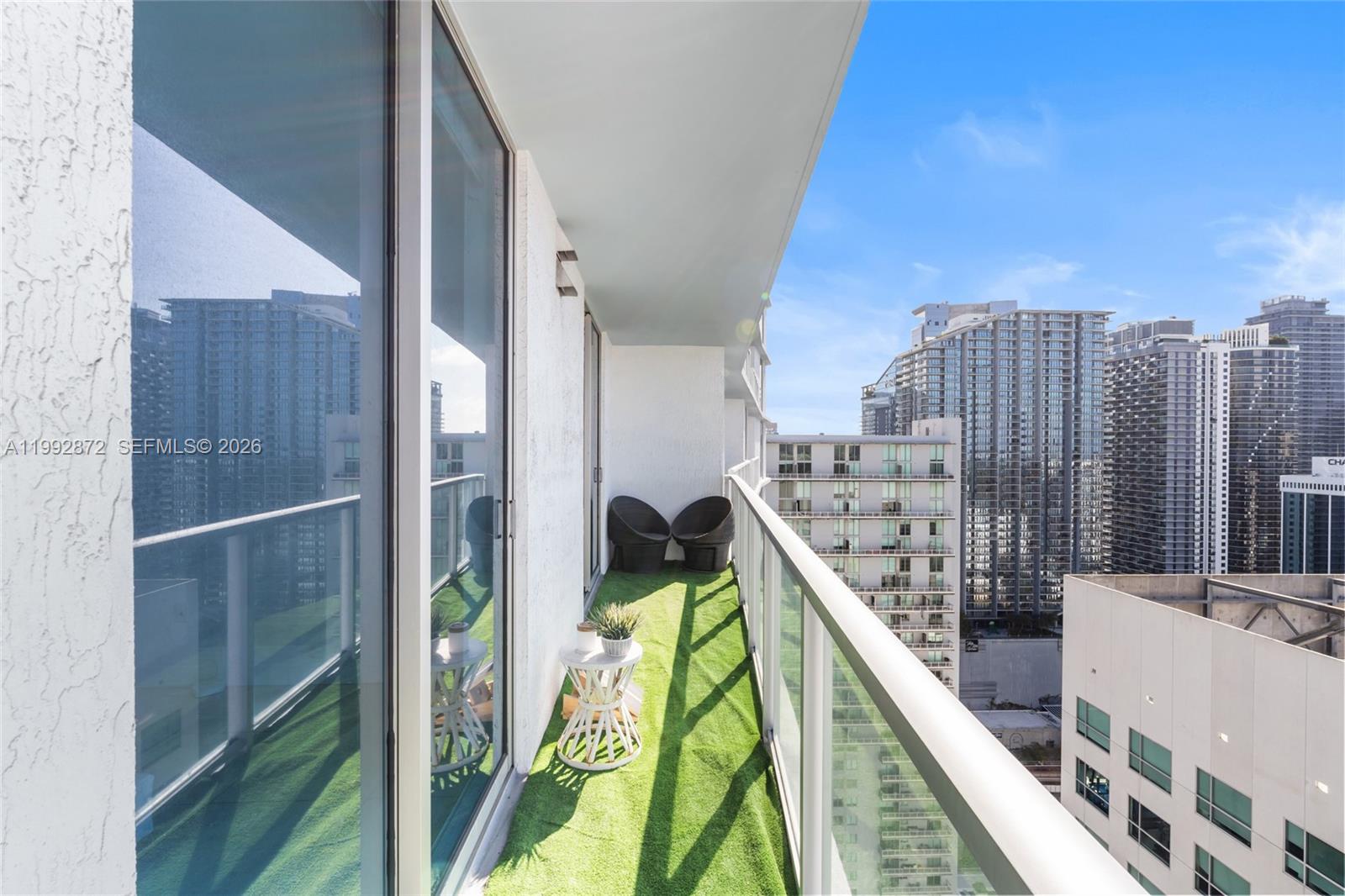 185 Southwest 7th Street, Unit 3414 Miami, FL 33130 - Photo 27 of 32 a balcony with tall trees