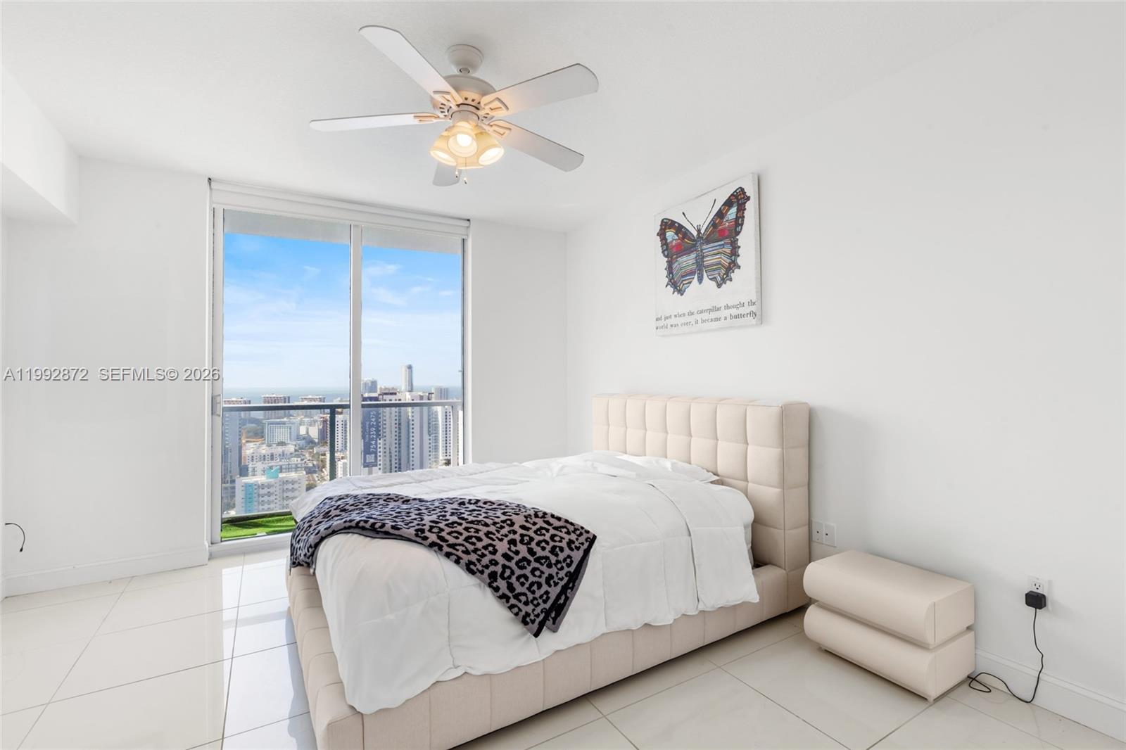 185 Southwest 7th Street, Unit 3414 Miami, FL 33130 - Photo 29 of 32 a bedroom with a bed and a chandelier