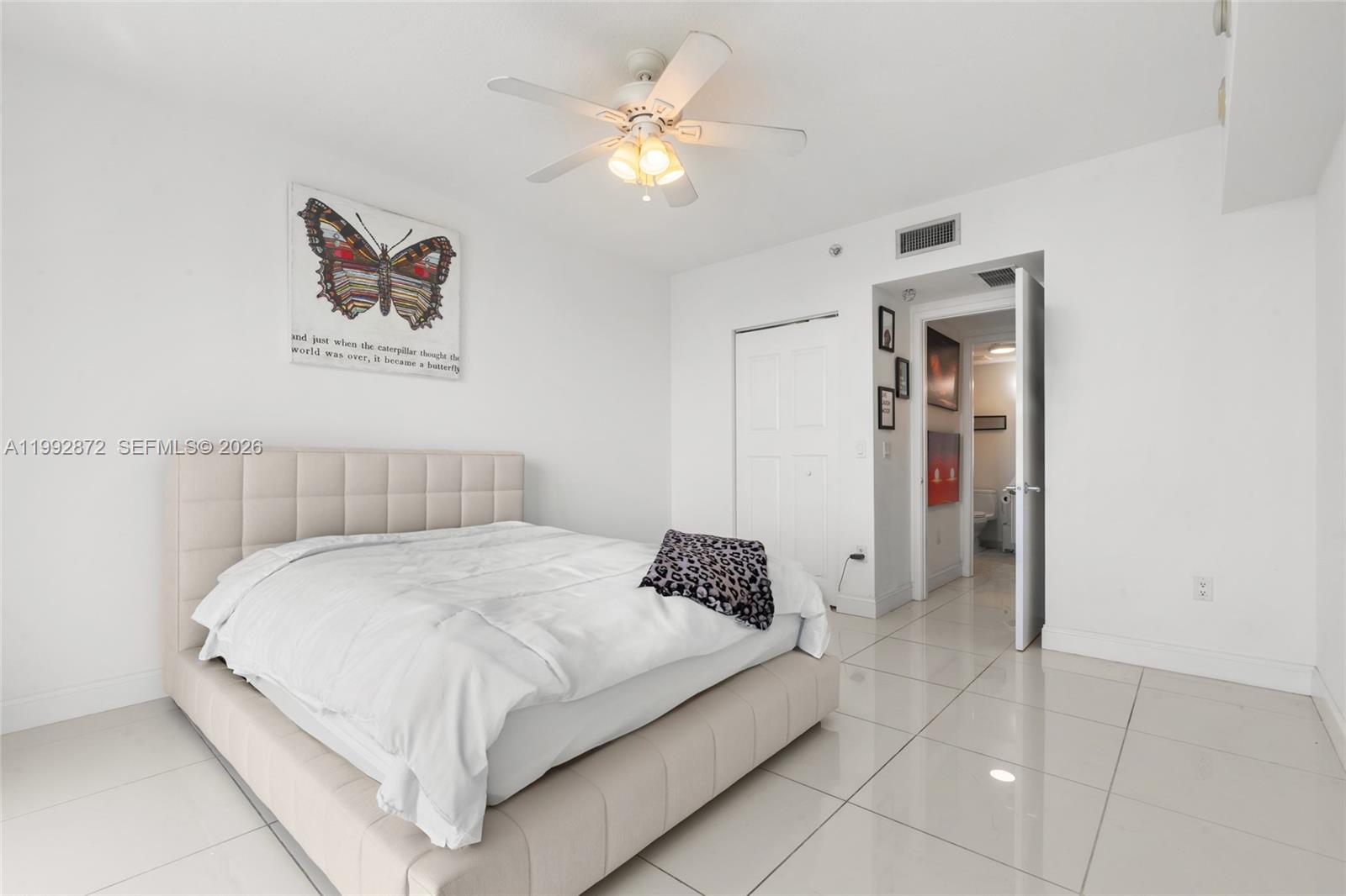 185 Southwest 7th Street, Unit 3414 Miami, FL 33130 - Photo 30 of 32 a bedroom with a bed and a chandelier