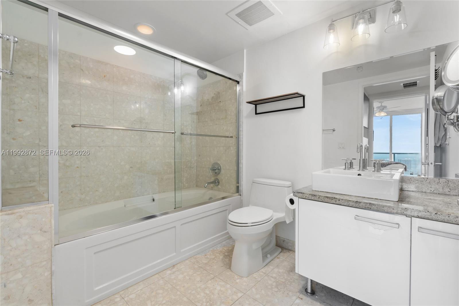 185 Southwest 7th Street, Unit 3414 Miami, FL 33130 - Photo 31 of 32 a bathroom with a sink toilet and shower