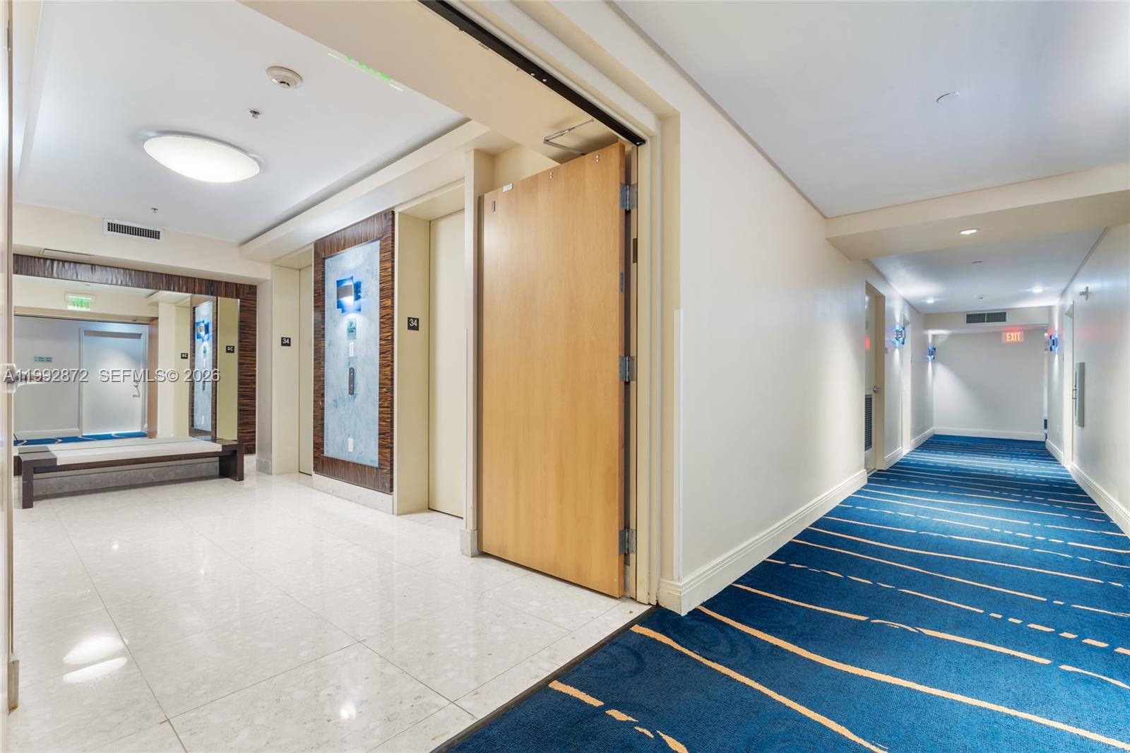 185 Southwest 7th Street, Unit 3414 Miami, FL 33130 - Photo 8 of 32 a view of a hallway with wooden floor and staircase