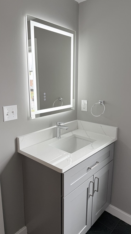 944 East Street, Unit 3 Walpole, MA 02081 - Photo 19 of 23 a bathroom with a sink and a vanity