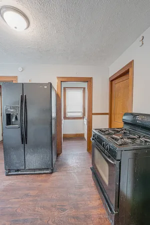 a kitchen with stainless steel appliances granite countertop a stove a refrigerator and a sink