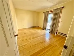 a view of a room with wooden floor and door
