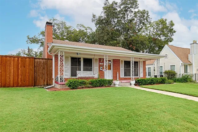a front view of a house with a garden and yard