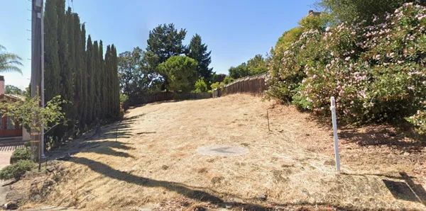 a view of a yard covered with snow in front of house