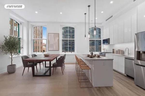 a view of a living room that has a window and a kitchen view