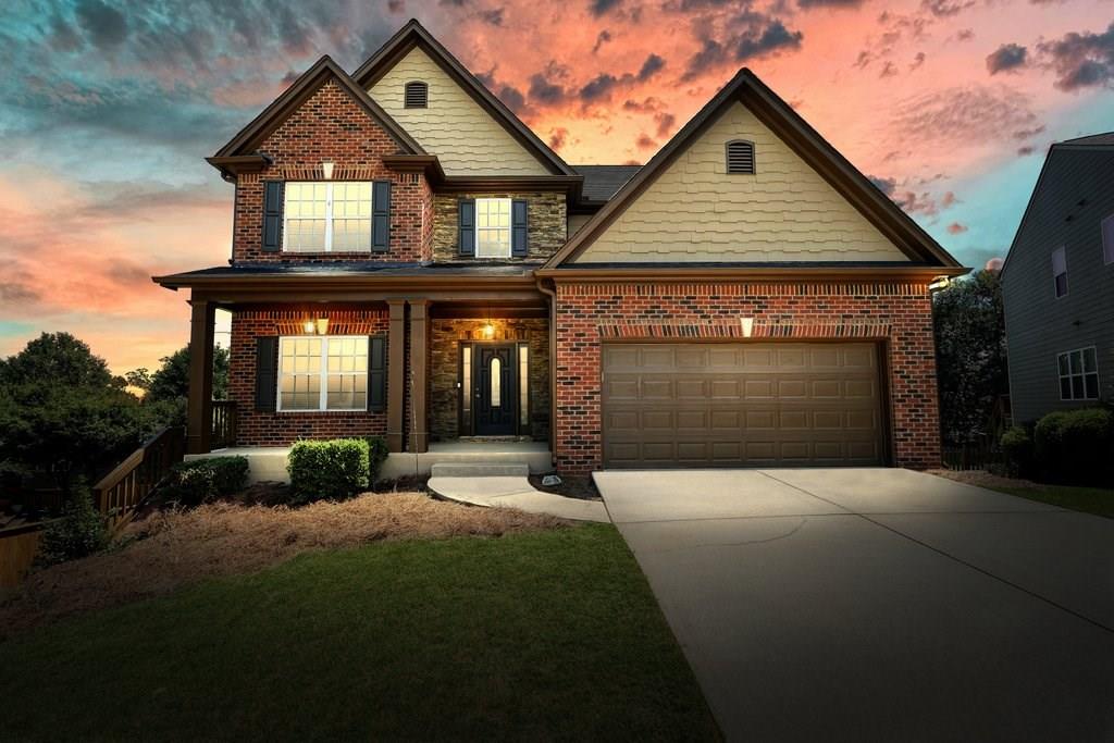 a front view of a house with a yard and garage