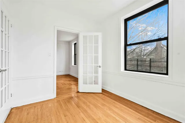 a view of an empty room with wooden floor