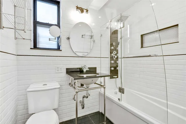 a bathroom with a sink a toilet and bathtub