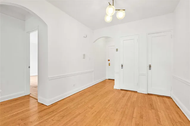 a view of a room with wooden floor