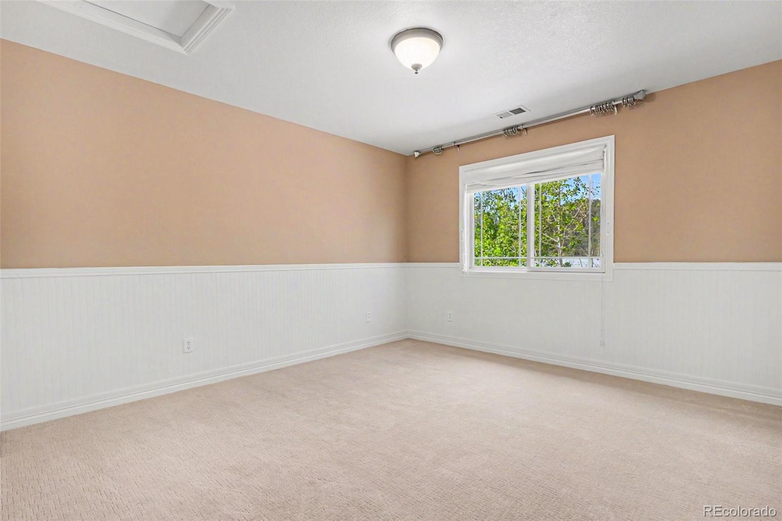 791 Elk Rest Road Evergreen, CO 80439 - Photo 24 of 46 an empty room with windows