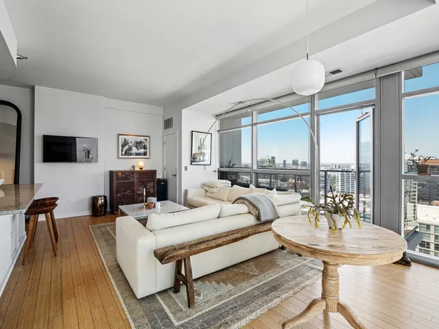 a living room with furniture and kitchen view
