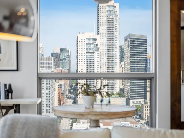 a view of a living room and kitchen with furniture