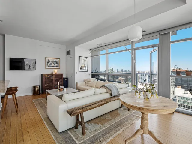 a living room with furniture a table and a flat screen tv