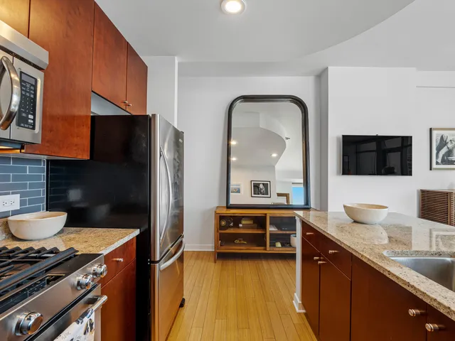 a kitchen with stainless steel appliances a sink stove and refrigerator
