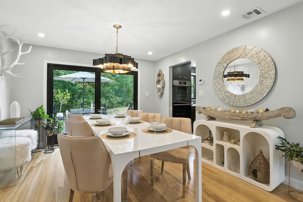 30 Linda Road Andover, MA 01810 - Photo 12 of 42 a dining room with wooden floor a chandelier
