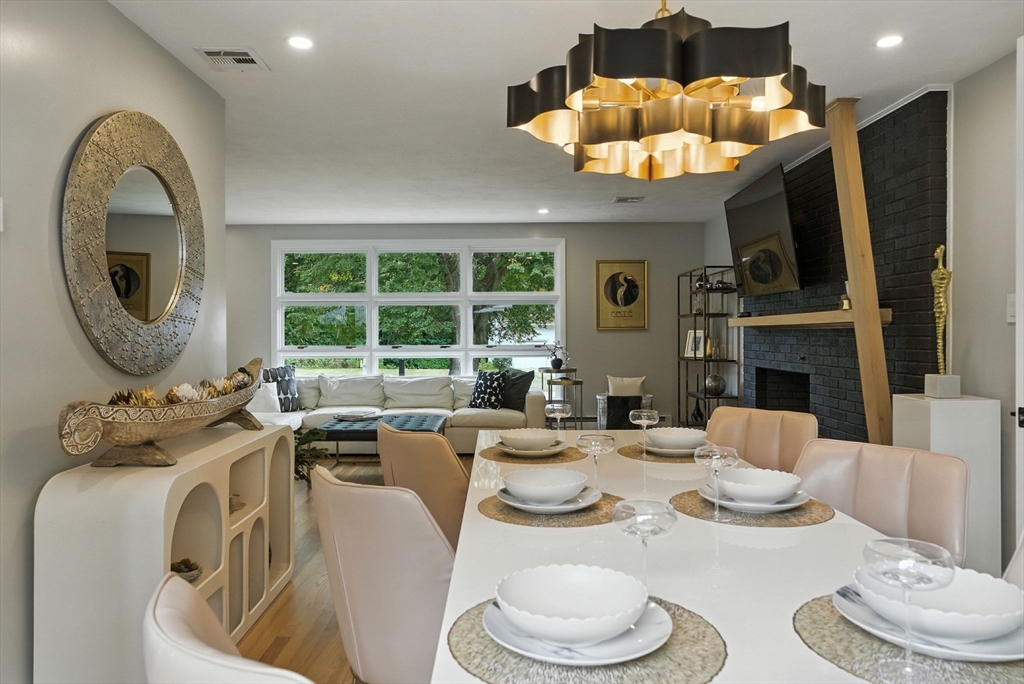 30 Linda Road Andover, MA 01810 - Photo 14 of 42 a dining room with furniture a large window and a chandelier