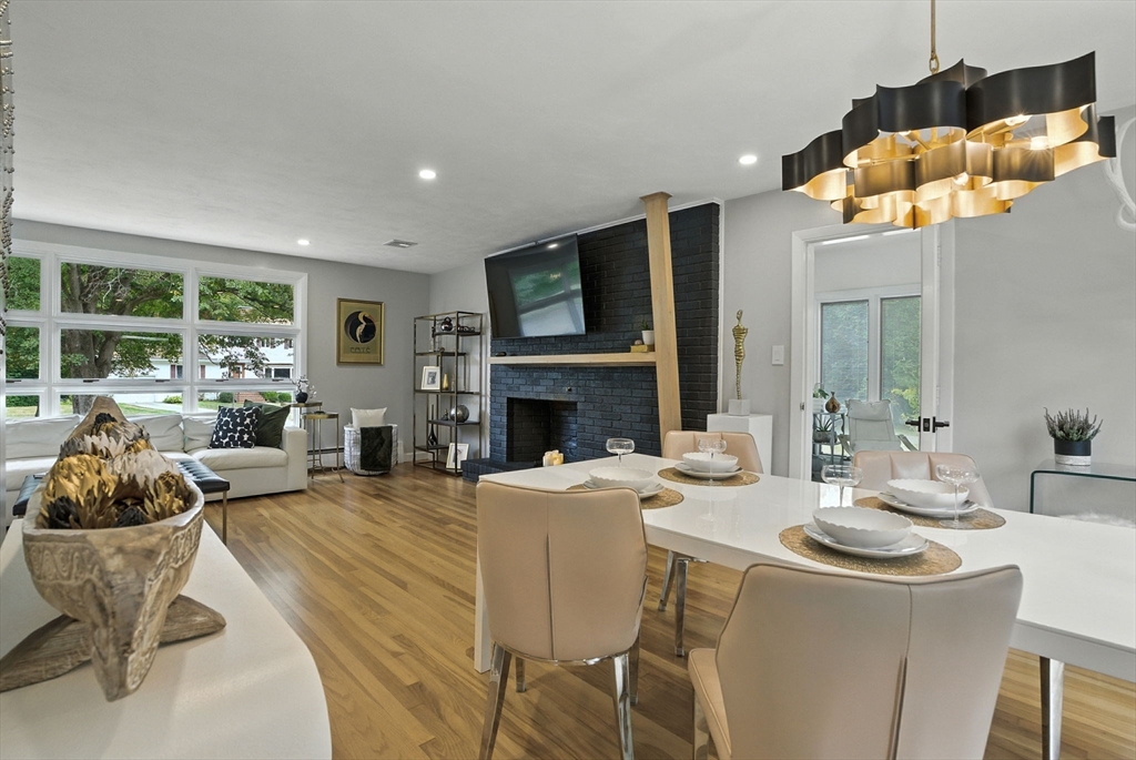 30 Linda Road Andover, MA 01810 - Photo 15 of 42 a dining room with furniture a fireplace and large windows