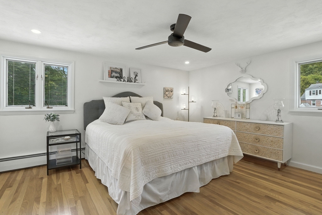 30 Linda Road Andover, MA 01810 - Photo 24 of 42 a bedroom with a large bed and a chandelier