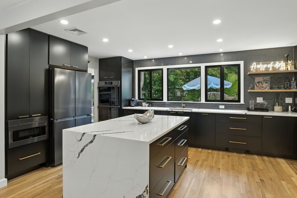 30 Linda Road Andover, MA 01810 - Photo 5 of 42 a kitchen with stainless steel appliances kitchen island granite countertop a refrigerator and a sink