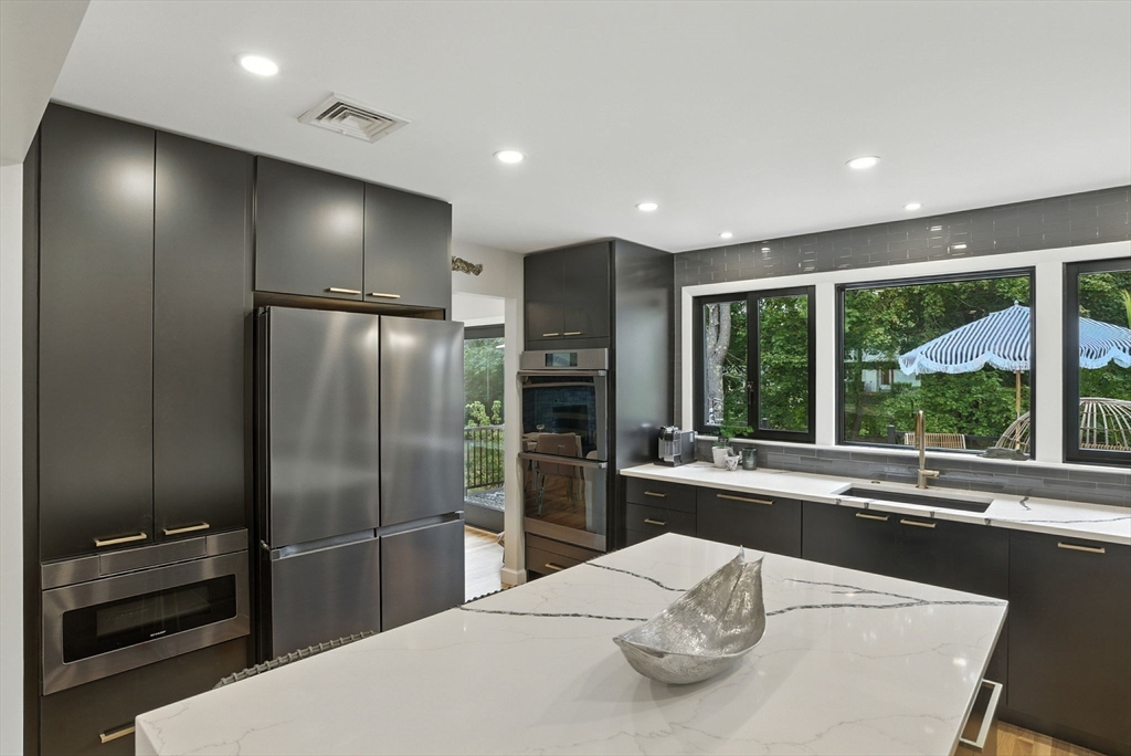 30 Linda Road Andover, MA 01810 - Photo 10 of 42 a kitchen with a refrigerator and a sink