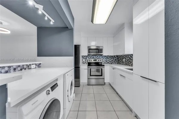 a kitchen with a stove sink and a refrigerator