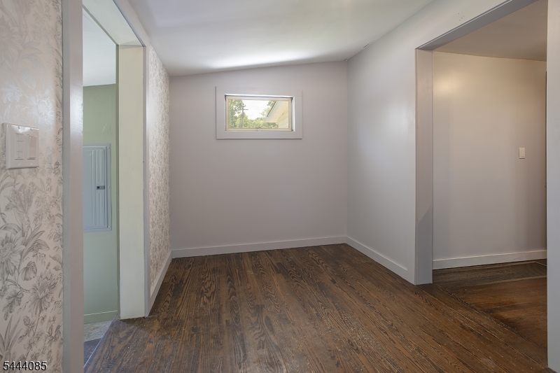 79 Lake Wallkill Road Vernon, NJ 07461 - Photo 16 of 27 an empty room with wooden floor and windows