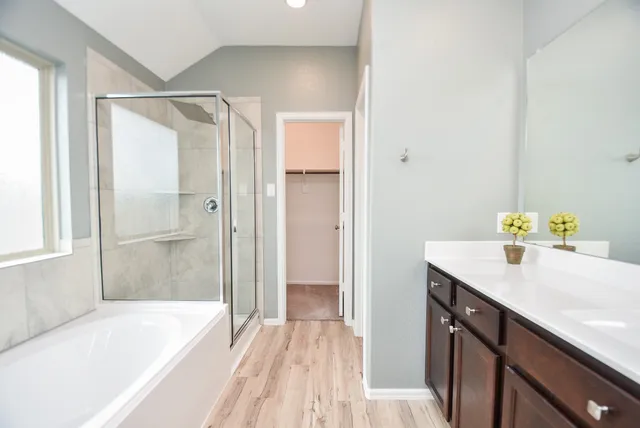 a bathroom with a tub sink and shower